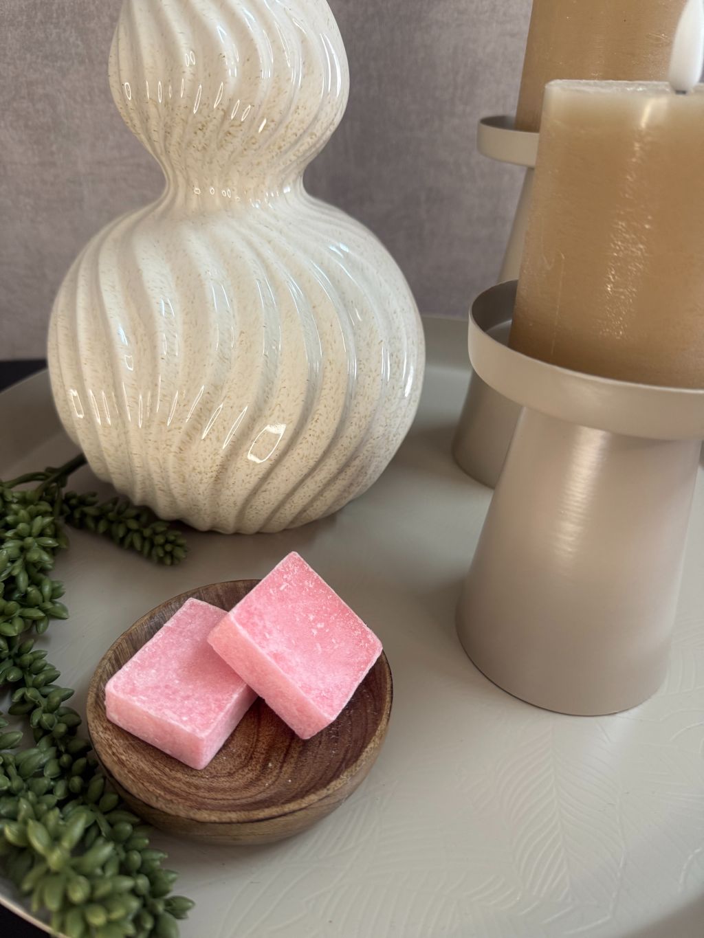 Decoratieset op beige dienblad met golvende vaas, kunsttakken, LED-kaarsen en amberblokjes in een houten schaaltje.