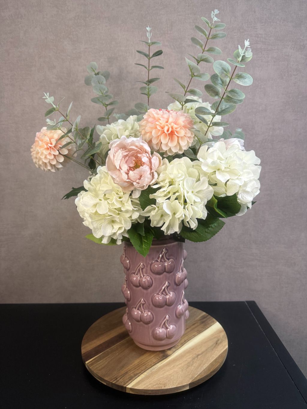 Kunstboeket Amélie – zachte bloemen in ecru, roze en zalmtinten met eucalyptus, in roze vaas met kersenmotief.